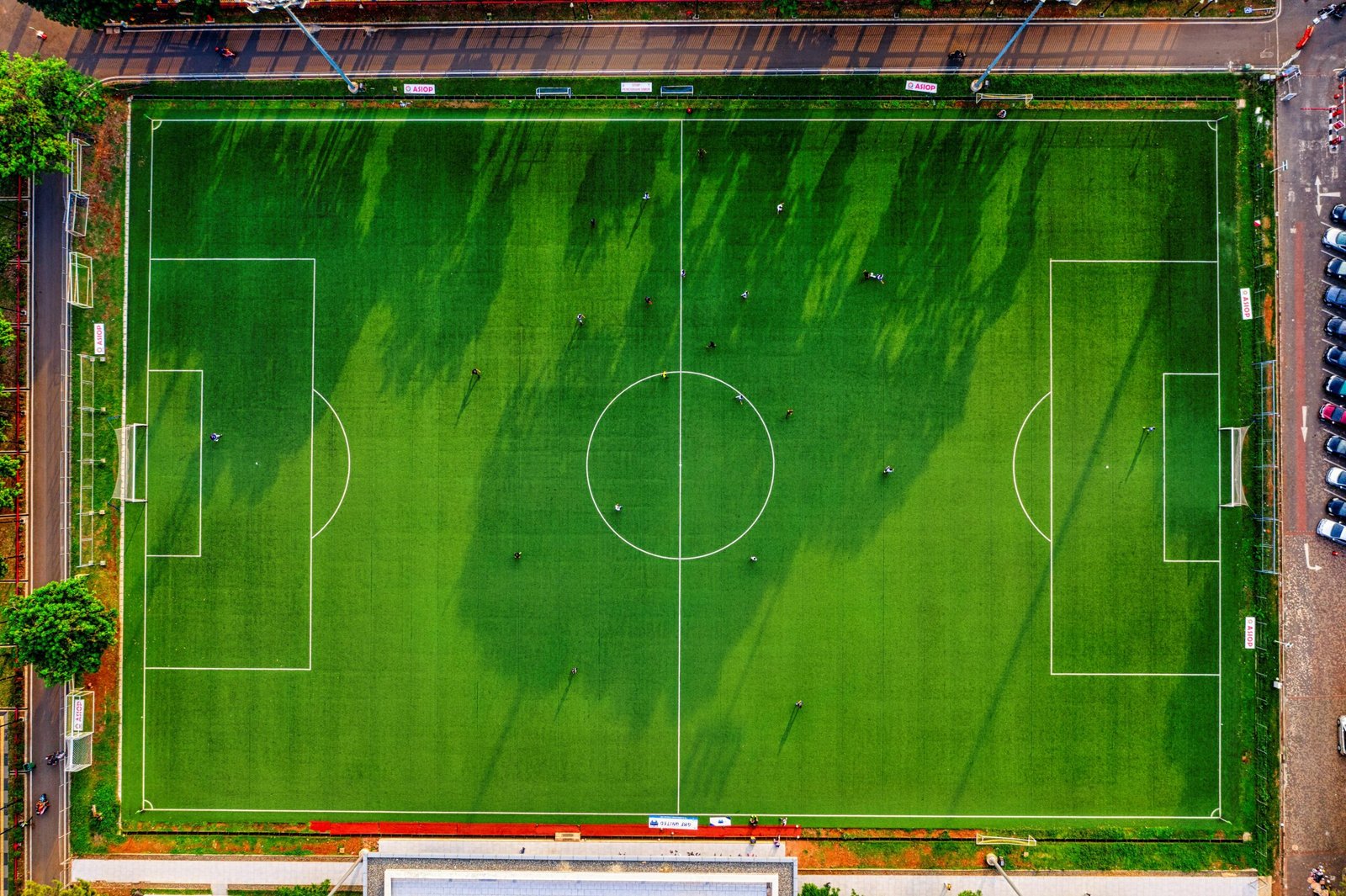 Drone shot of a soccer field in Jakarta, Indonesia with players practicing.